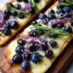 Blueberry brie flatbread topped with lemon zest and rosemary honey