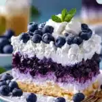 Blueberry Cloud Cake with fluffy icing and fresh blueberries on top