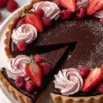 Chocolate strawberry raspberry ganache tart topped with fresh berries