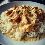 Creamy chicken and rice in a creamy sauce topped with herbs and vegetables