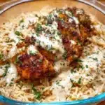 High protein creamy Cajun chicken served over rice in a bowl.