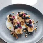 Blueberry crumble banana split topped with ice cream and fresh blueberries