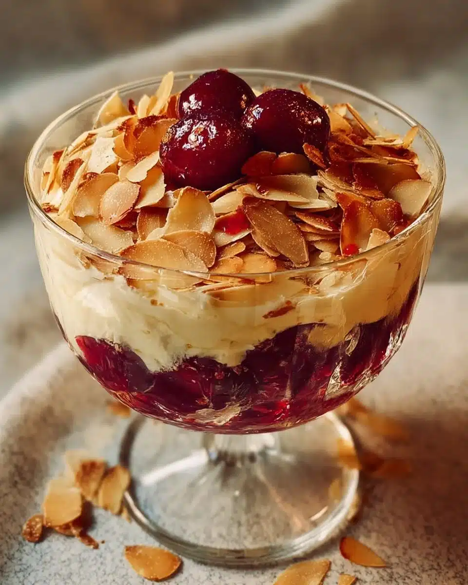 Delicious cherry almond dessert on a plate with fresh cherries and almonds.
