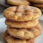 A plate of freshly baked churro cookies dusted with cinnamon sugar.