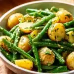 Creamy green bean potato salad in a bowl, perfect for summer gatherings.