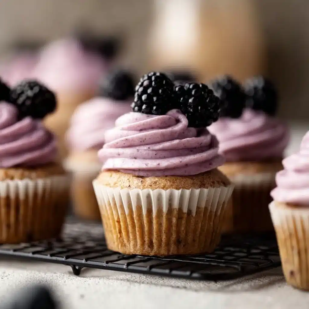 Earl Grey Blackberry Cupcakes with frosting and fresh blackberries on top