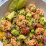 Colorful healthy shrimp avocado salad with fresh ingredients in a bowl