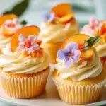 Honey peach cream cheese cupcakes topped with peach slices and cream frosting