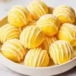 Delicious lemon cheesecake bites on a plate, perfect for dessert lovers.
