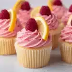 Lemon cupcakes with raspberry buttercream frosting on a decorative plate