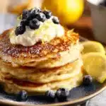 Fluffy Lemon Ricotta Pancakes served with fresh lemon slices and syrup