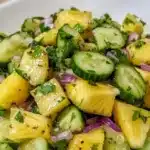 Fresh Pineapple Cucumber Salad in a bowl with vibrant toppings