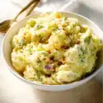 Delicious Southern potato salad in a bowl with fresh herbs