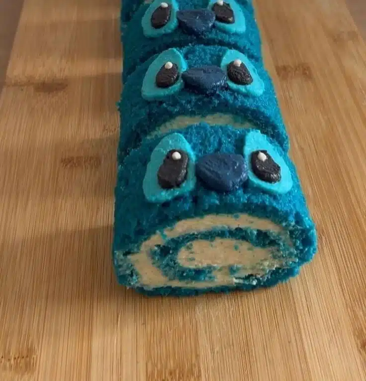 Stitch-inspired tropical blue cake roll on a colorful plate