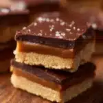 Delicious Twix Cookie Bars featuring cookie base, caramel, and chocolate layers.