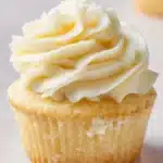 Delicious vanilla cupcakes topped with creamy frosting and sprinkles.