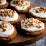 Freshly baked chewy carrot cake cookies on a plate