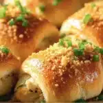 Chicken crescent roll ups filled with chicken and creamy sauce