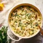 Creamy Lemon Chicken Orzo dish with fresh herbs and lemon slices