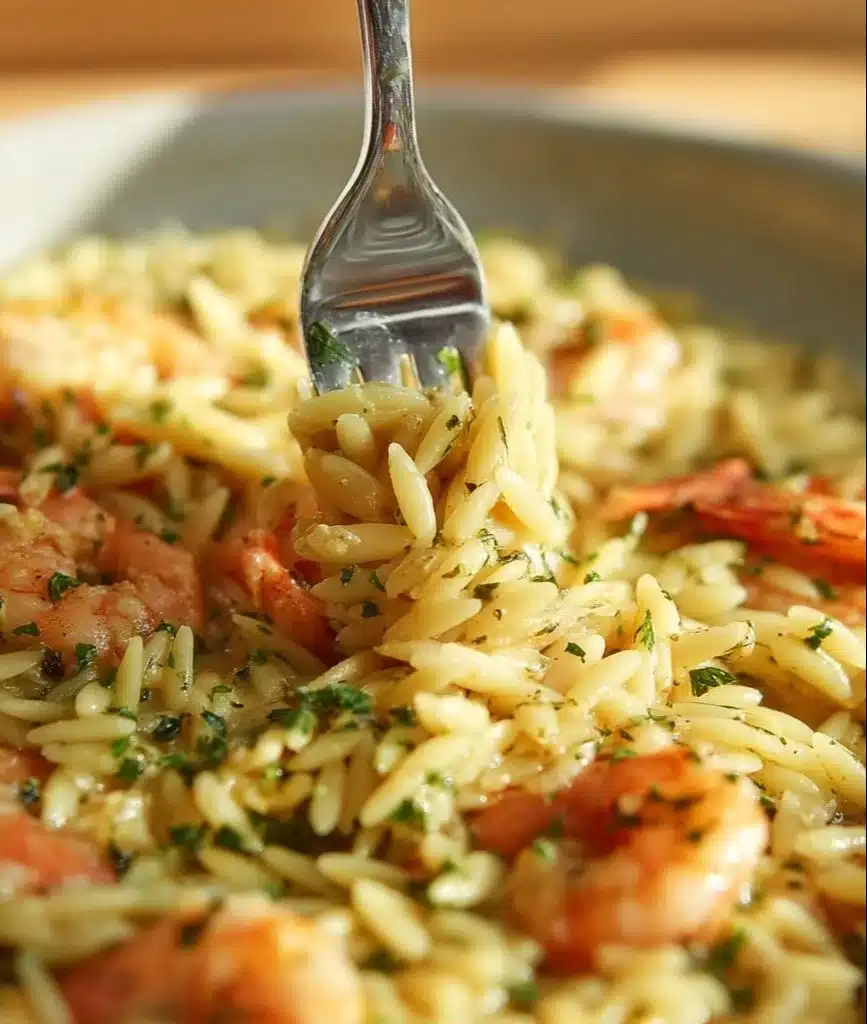 Delicious Garlic Butter Prawn Orzo served in a bowl with fresh herbs.