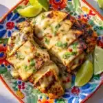 Grilled chicken served with vibrant green sauce for flavorful dining.