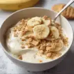 Healthy high protein banana pudding bowl topped with fresh bananas and nuts