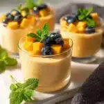 Delicious mango mousse dessert topped with fresh mango pieces.