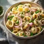 Bowl of colorful Tuna Pasta Salad with veggies and dressing