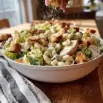 Chilled Chicken Caesar Pasta Salad garnished with parmesan and croutons.