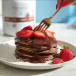 Delicious Chocolate Protein Pancakes served with fresh berries and syrup.