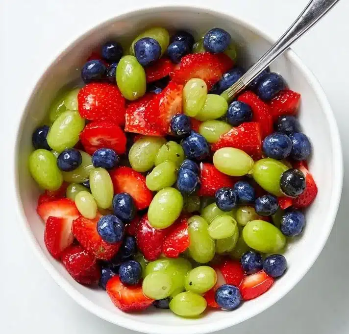 Colorful honey lime fruit salad with fresh fruits and a drizzle of honey
